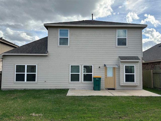 back of house featuring a patio area and a yard