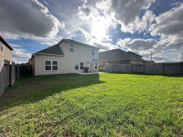 back of property with a lawn