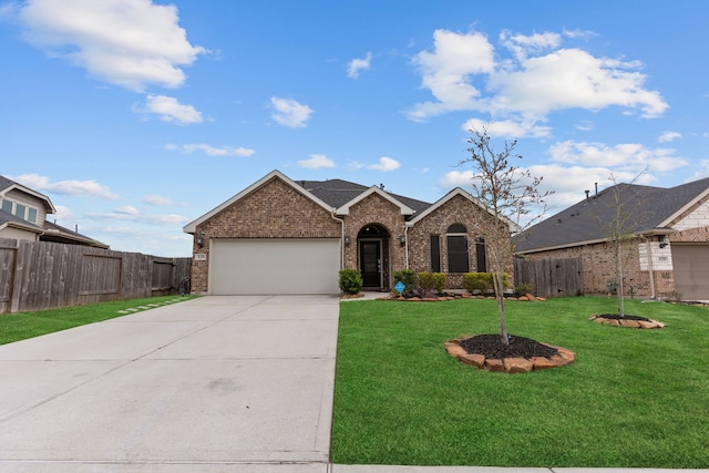 view of front of property featuring a front yard and a garage