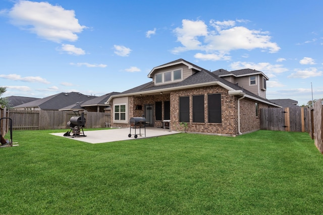 back of house with a lawn and a patio area