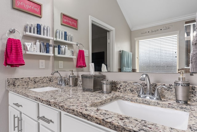 bathroom featuring ornamental molding, vanity, and lofted ceiling