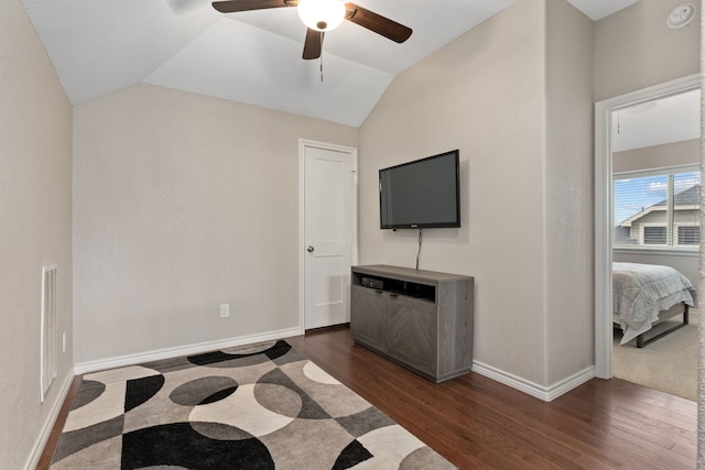 living room with dark hardwood / wood-style floors, vaulted ceiling, and ceiling fan