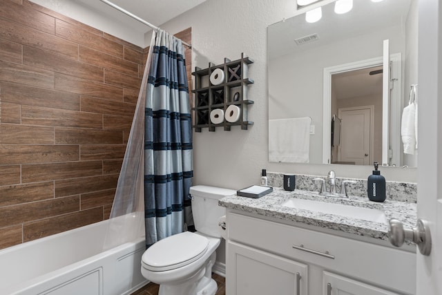 full bathroom featuring vanity, shower / bath combination with curtain, and toilet