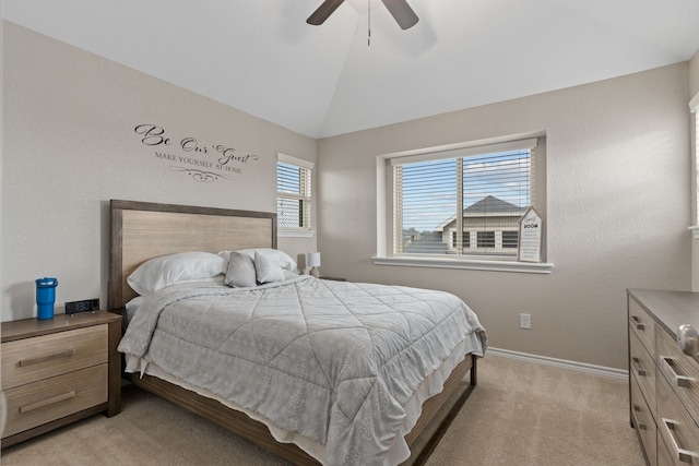 carpeted bedroom featuring ceiling fan and vaulted ceiling