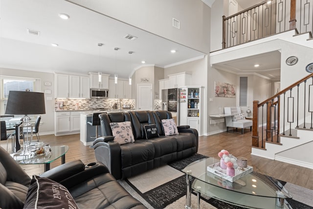 living room with hardwood / wood-style flooring and crown molding