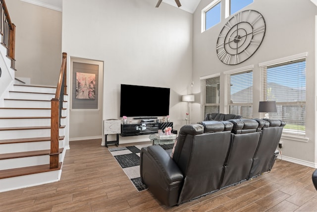 living room with ceiling fan and ornamental molding