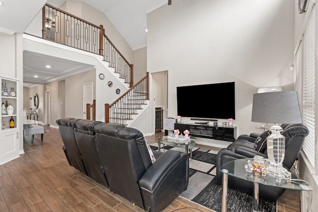 living room with high vaulted ceiling and ornamental molding