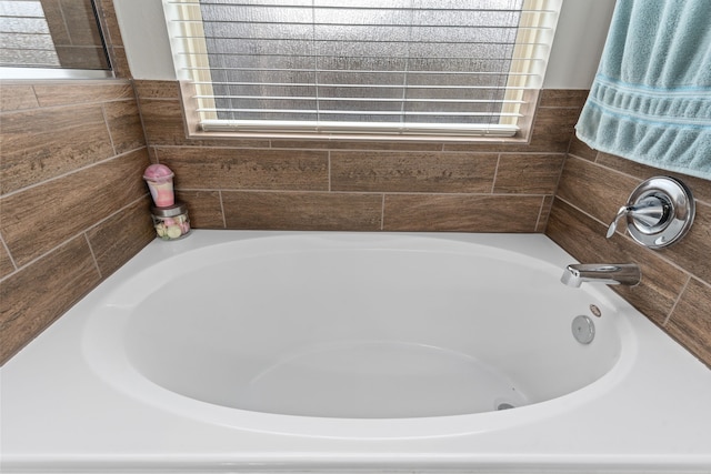 bathroom featuring a tub to relax in