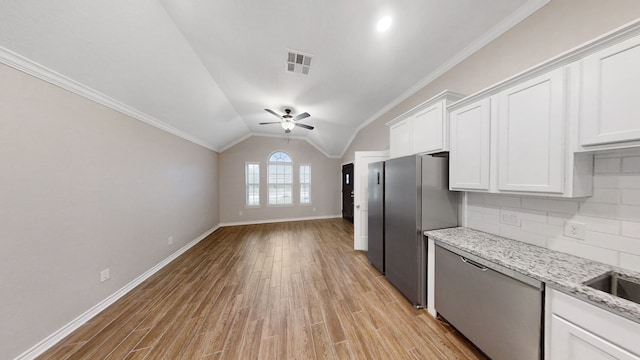 kitchen featuring white cabinets, crown molding, backsplash, and vaulted ceiling