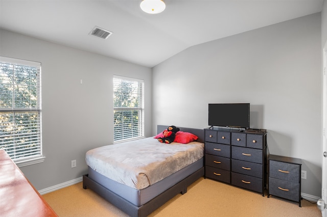 carpeted bedroom with vaulted ceiling