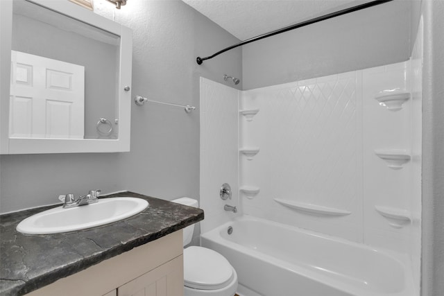 full bathroom with vanity, a textured ceiling, toilet, and tub / shower combination