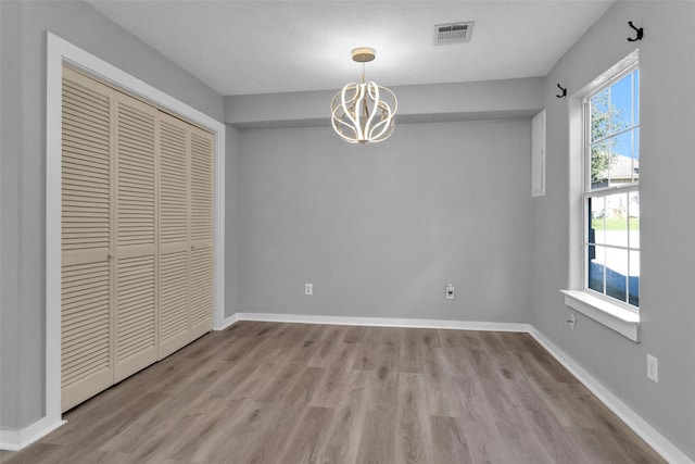 509 Spruce Dr, Conroe, TX 77302 - unfurnished dining area featuring a chandelier, wood finished floors, and baseboards