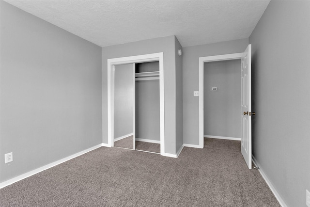 509 Spruce Dr, Conroe, TX 77302 - unfurnished bedroom featuring carpet flooring, a textured ceiling, a closet, and baseboards