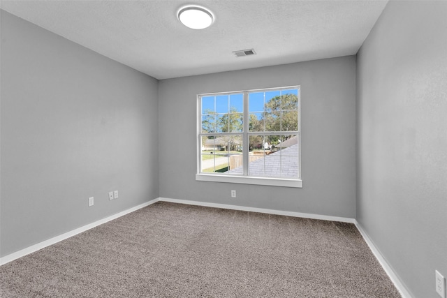 509 Spruce Dr, Conroe, TX 77302 - spare room featuring carpet, baseboards, and a textured ceiling