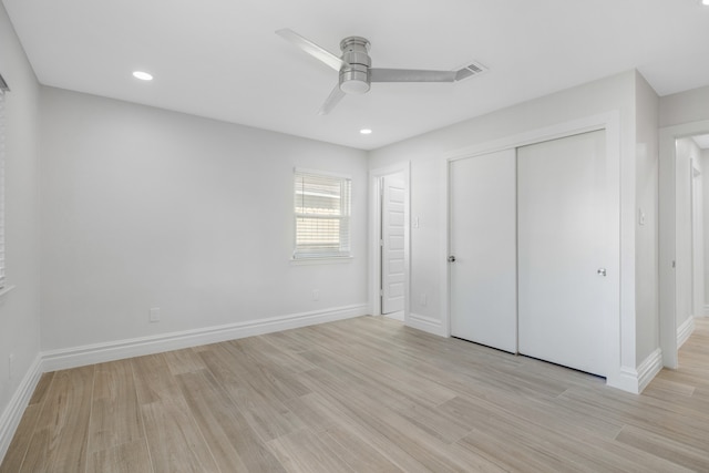 unfurnished bedroom with light wood-type flooring, a closet, and ceiling fan