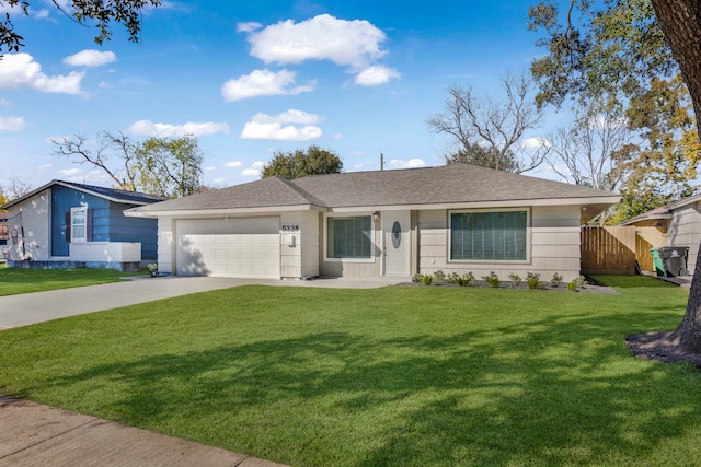 ranch-style home with a garage and a front lawn