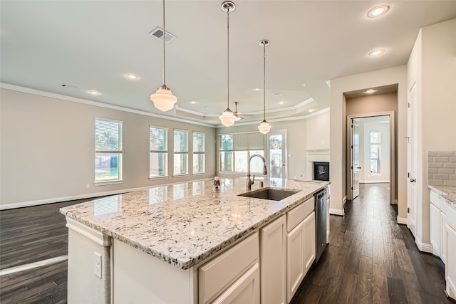 kitchen with a kitchen island with sink, a wealth of natural light, and sink