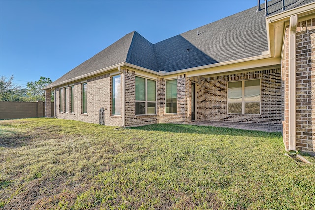 back of house with a lawn