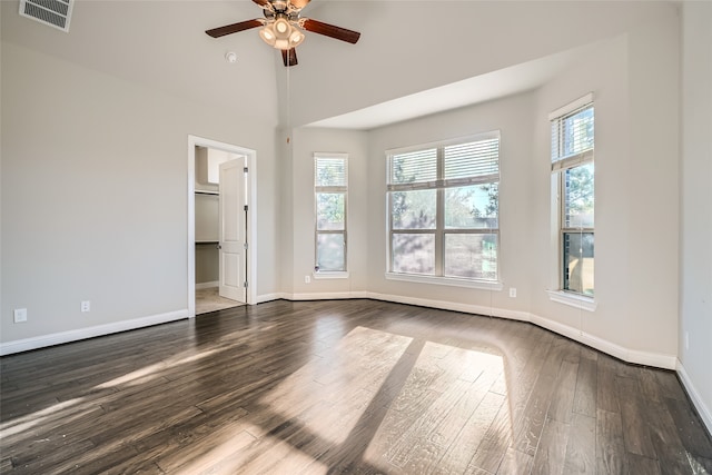 unfurnished room with dark hardwood / wood-style floors and ceiling fan