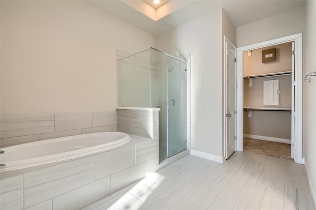 bathroom featuring separate shower and tub