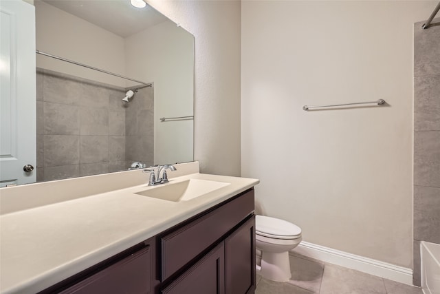 bathroom with tile patterned flooring, vanity, and toilet