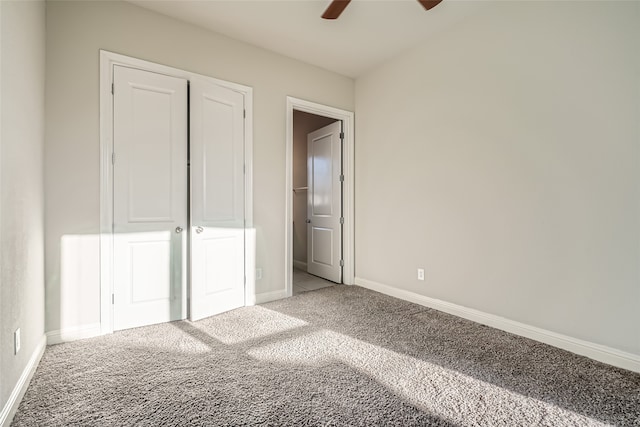 unfurnished bedroom with ceiling fan, a closet, and carpet