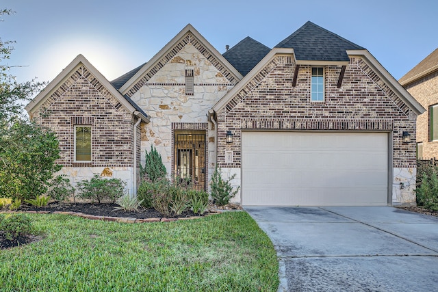 view of front of home with a garage and a front yard