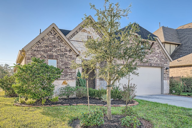 view of front of property with a front yard and a garage