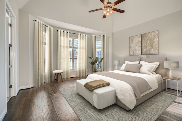 bedroom featuring hardwood / wood-style floors, ceiling fan, and high vaulted ceiling