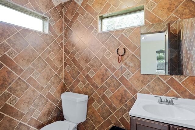 bathroom with vanity and tile walls