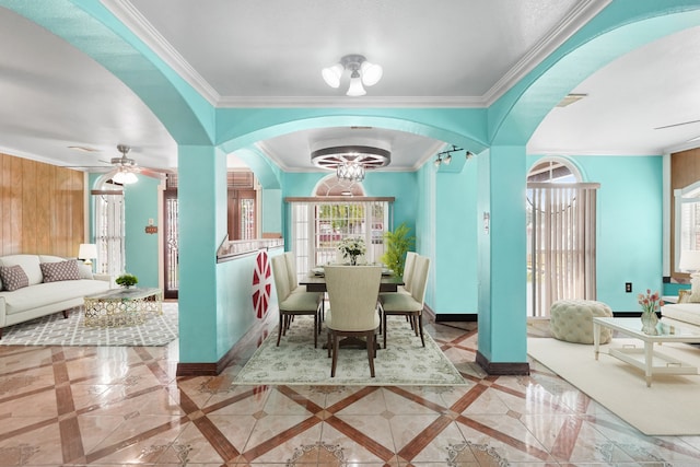 dining area with crown molding and ceiling fan