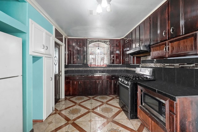 kitchen with appliances with stainless steel finishes, backsplash, dark brown cabinetry, sink, and light tile patterned floors