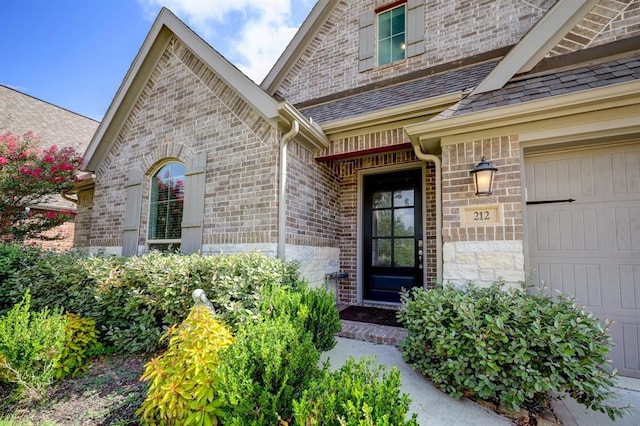 doorway to property with a garage