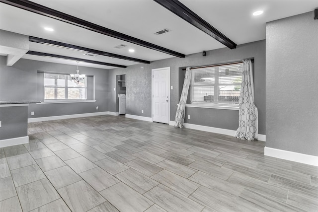 unfurnished living room featuring beamed ceiling and a notable chandelier