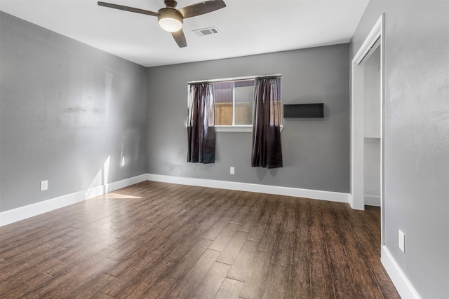 unfurnished room with dark hardwood / wood-style flooring and ceiling fan