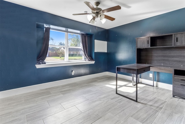 unfurnished office featuring ceiling fan