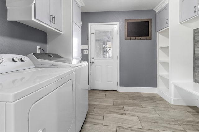 washroom featuring cabinets and washer and clothes dryer