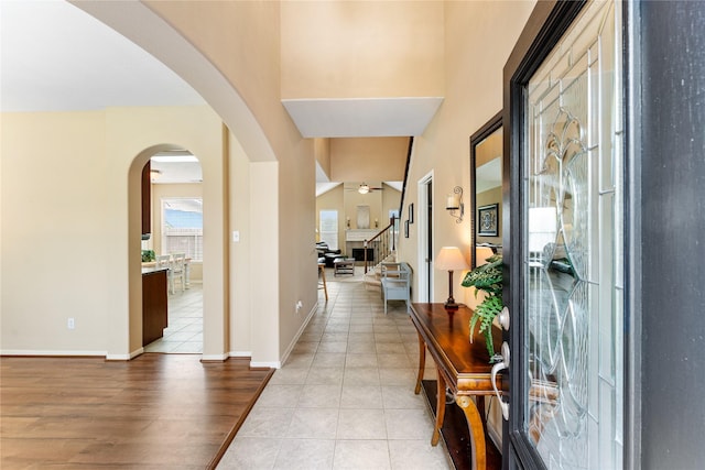 entrance foyer featuring light tile patterned floors and ceiling fan