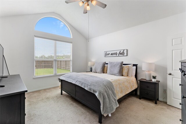 bedroom featuring vaulted ceiling, multiple windows, baseboards, and light colored carpet