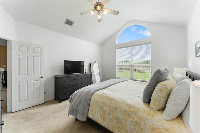 carpeted bedroom featuring lofted ceiling, visible vents, and a ceiling fan