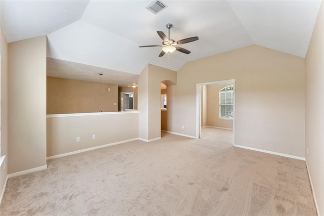 empty room featuring baseboards, visible vents, lofted ceiling, ceiling fan, and carpet floors