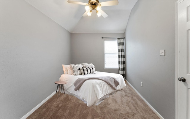 carpeted bedroom with lofted ceiling, ceiling fan, and baseboards