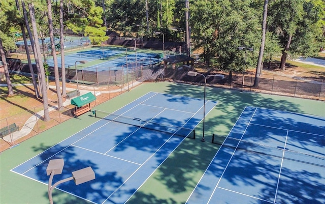 view of tennis court featuring fence