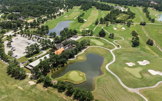 birds eye view of property with a water view and golf course view