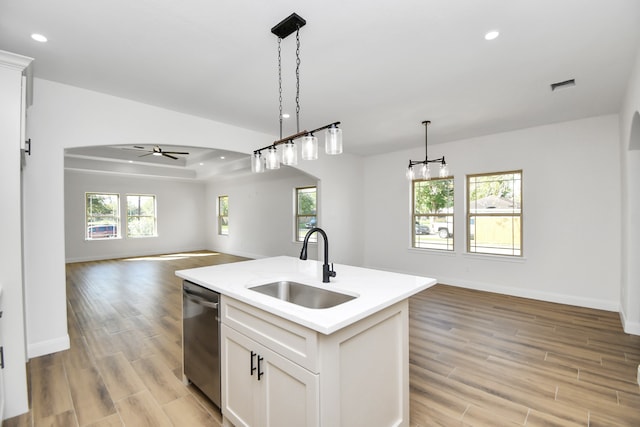 kitchen with white cabinetry, dishwasher, plenty of natural light, a kitchen island with sink, and light wood-type flooring