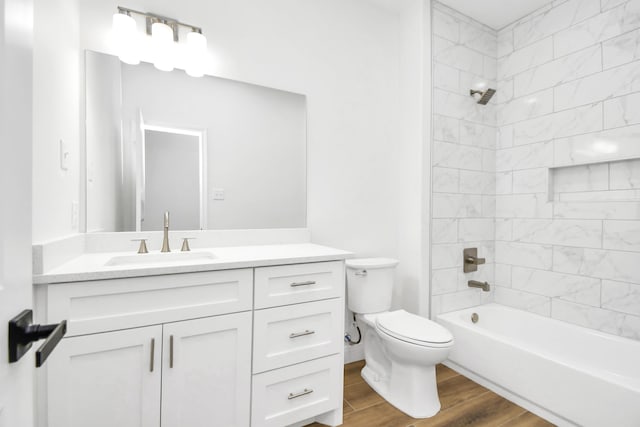 full bathroom featuring wood-type flooring, vanity, toilet, and tiled shower / bath