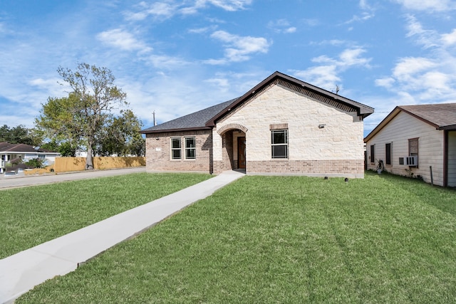 french country inspired facade with a front yard