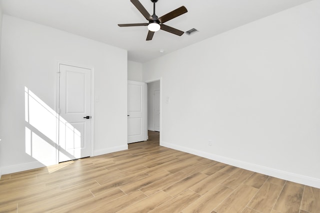 spare room featuring light wood-type flooring and ceiling fan