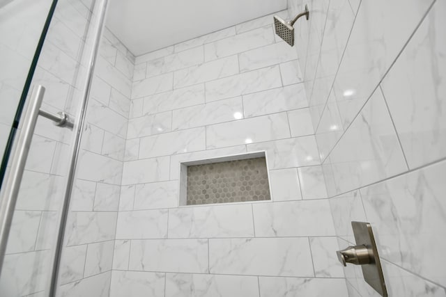 bathroom with tiled shower