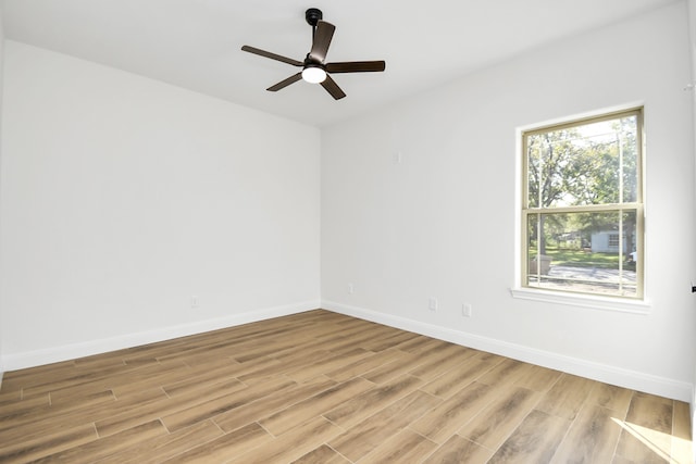 empty room featuring ceiling fan and light hardwood / wood-style flooring